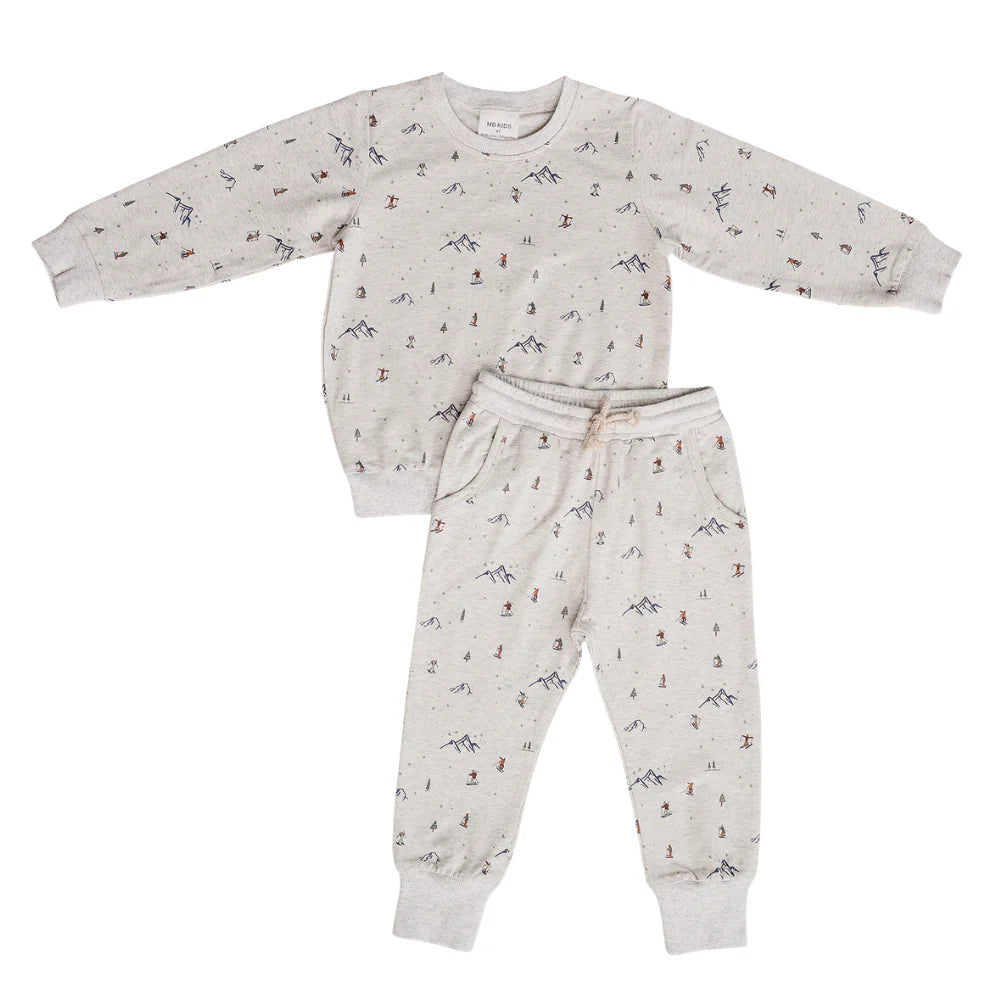 A two-piece children's loungewear set consisting of a long-sleeve sweatshirt and matching jogger pants, both in a light grey heather fabric with a small, scattered multicolor mountain and skier print, shown on a plain white background.