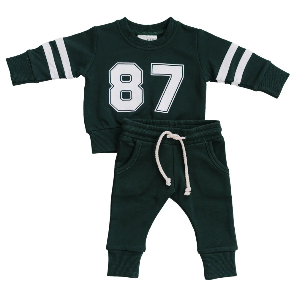 Green children's sweatshirt and pants set with number 87 and w white rope drawstring on a white background
