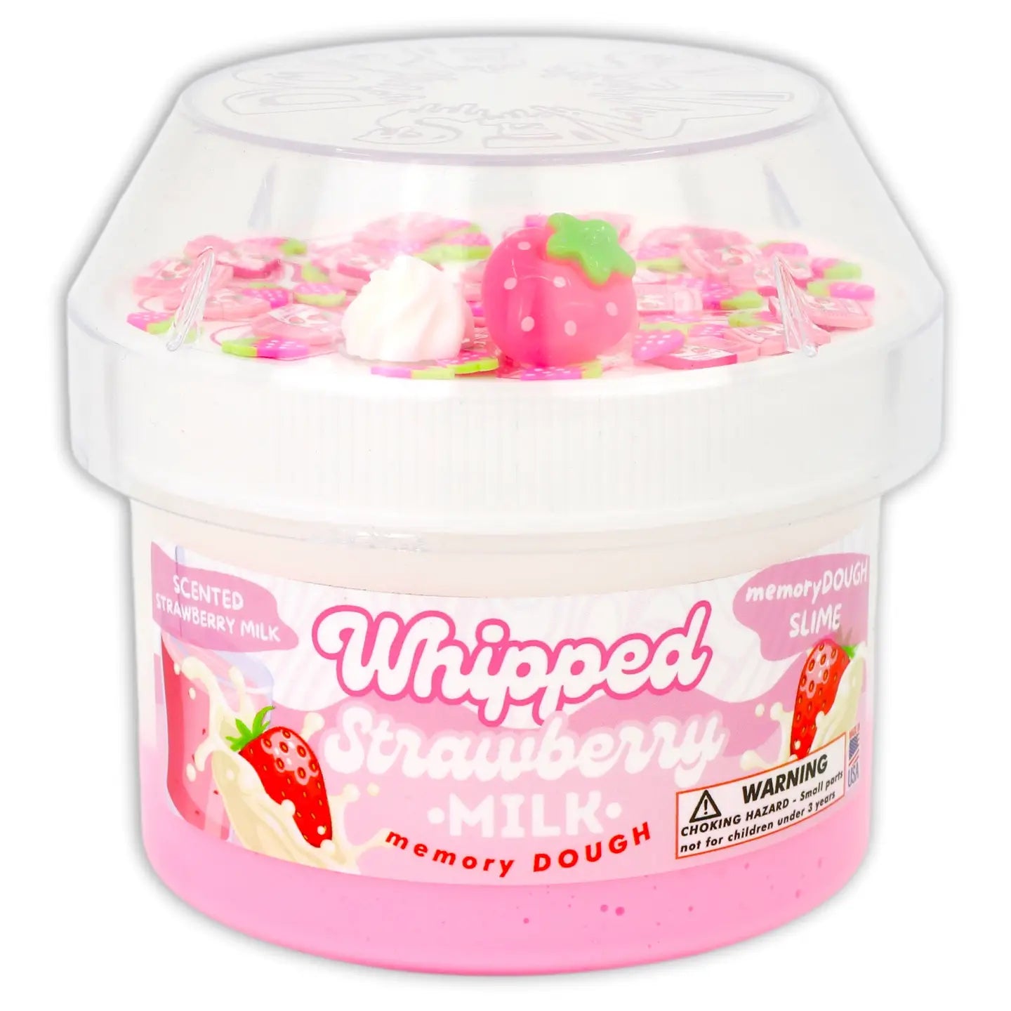 Pink whipped memory dough container with strawberry milk scent and accessories on a white background