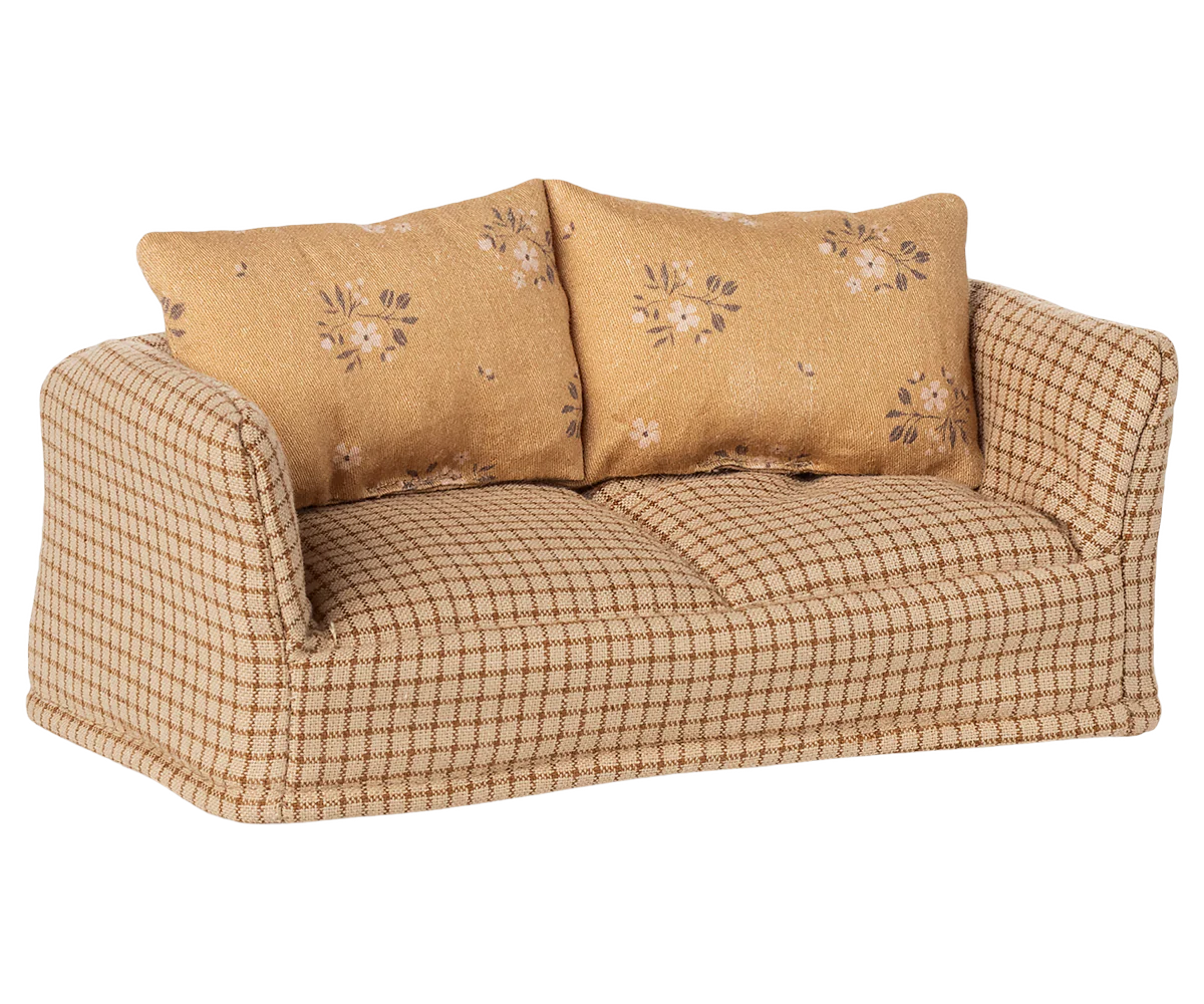 Beige gingham sofa with floral patterned cushions