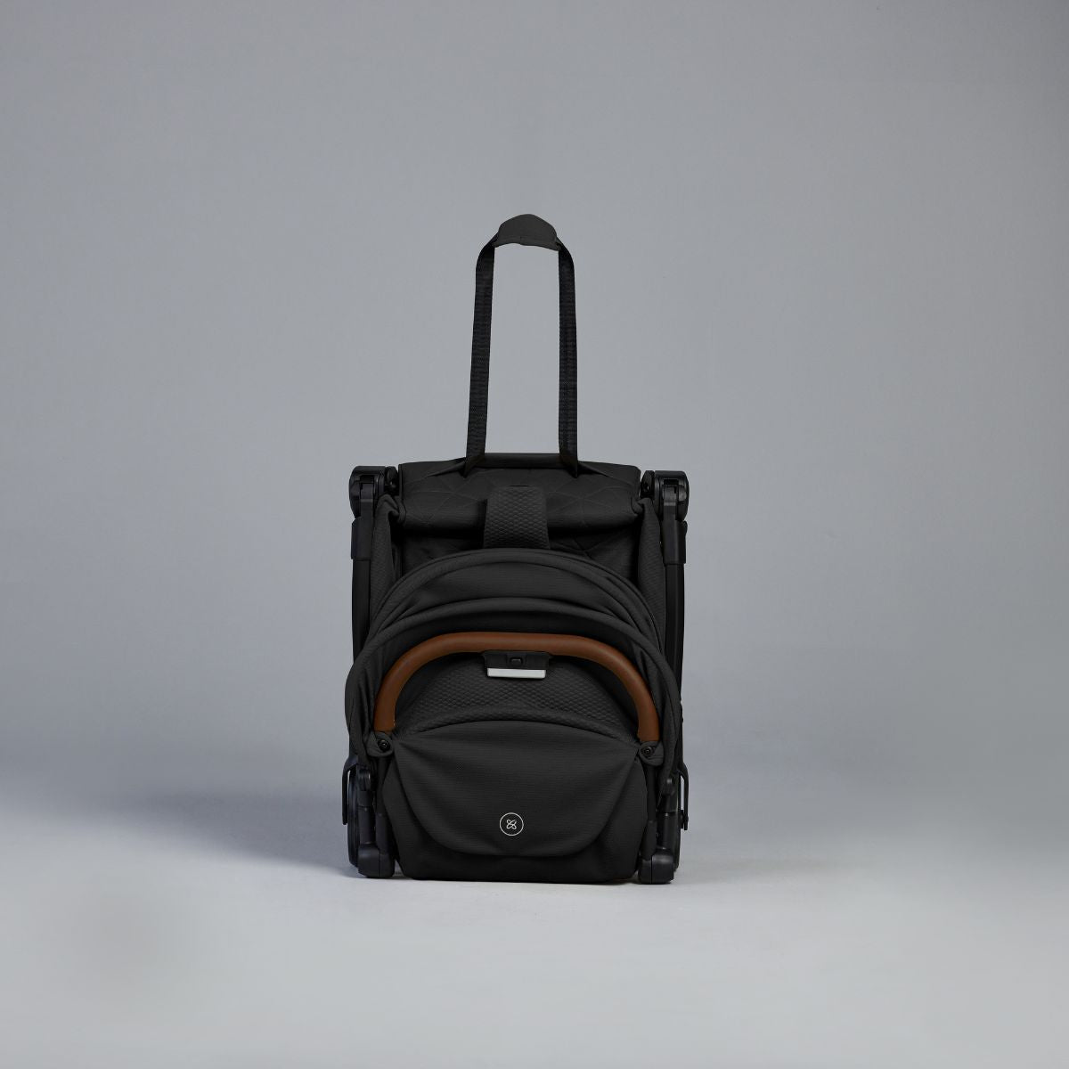 Black rolling Travel Stroller on a gray background