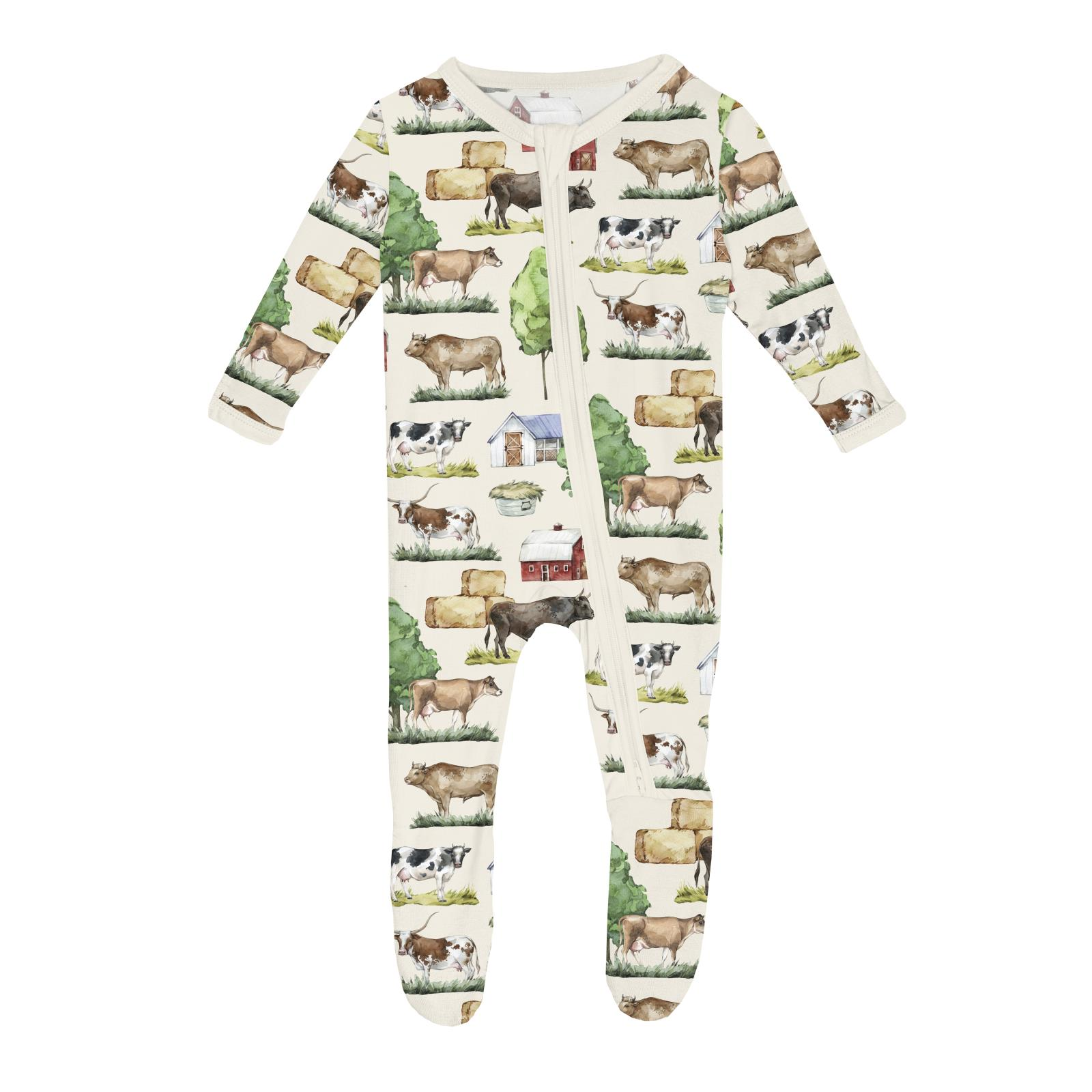 Baby onesie with farm animal pattern on a white background