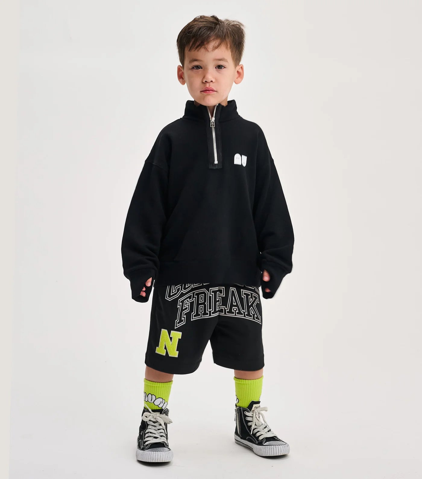 child wearing a black sweatshirt with white background