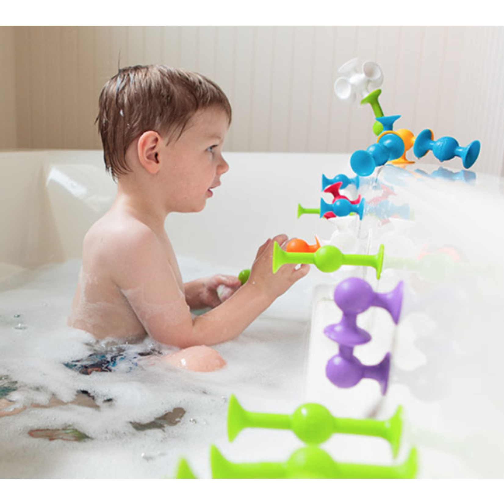 kids playing with suction toys in bath