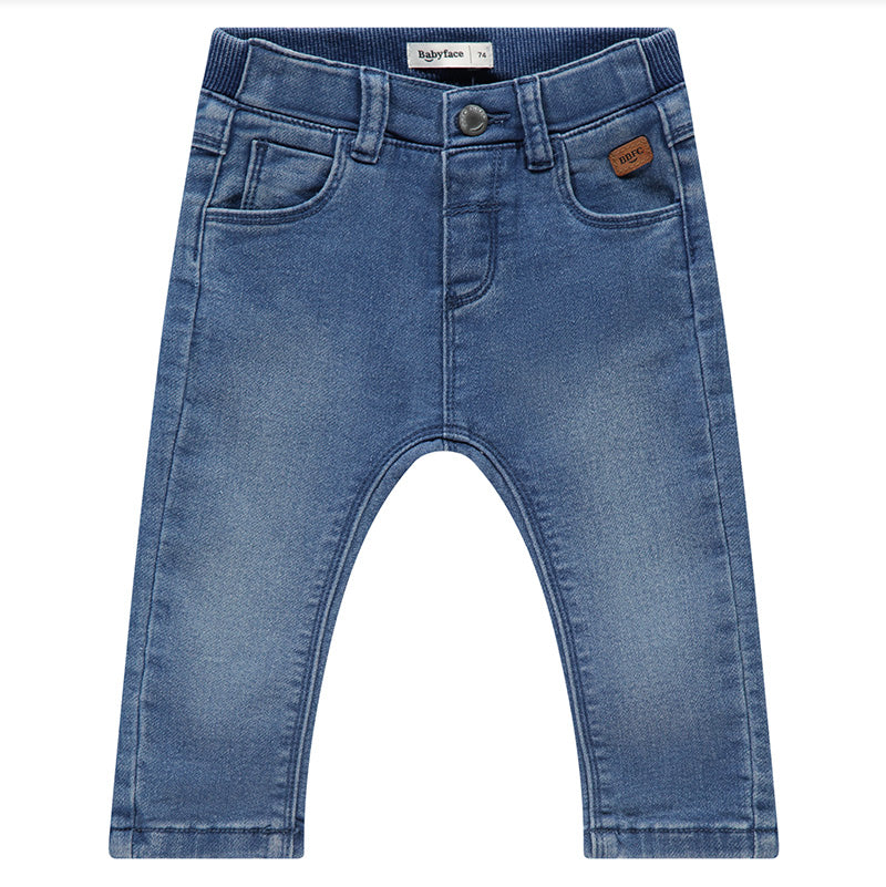 Mid wash blue denim baby boys' pants with a button and zip closure, featuring an elasticated waistband and belt loops.