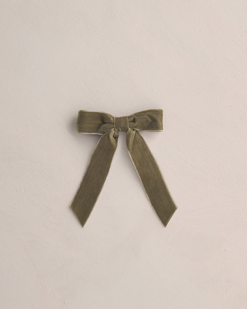 Green bow on a beige background