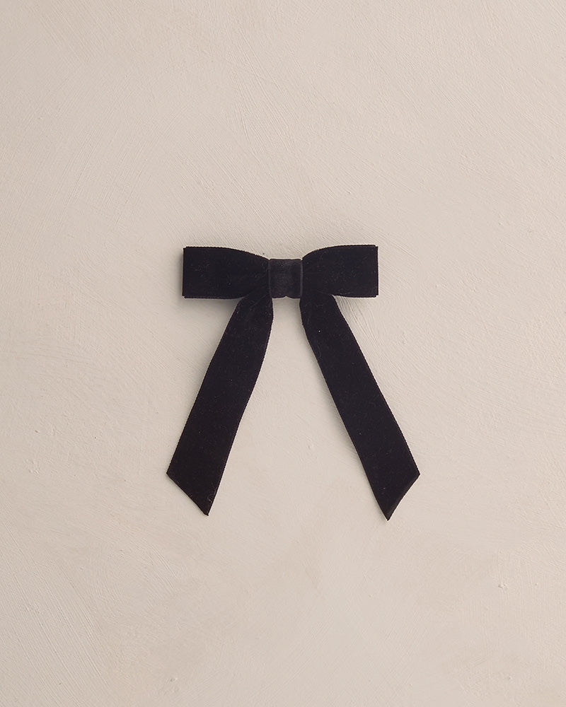 Black bow on a beige background
