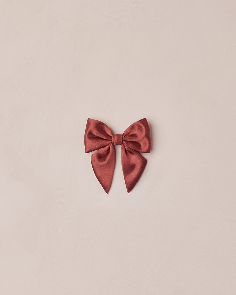 Red bow on a beige background