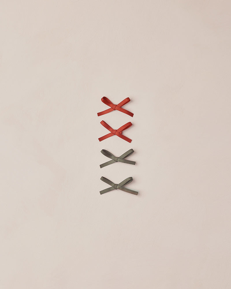 Four decorative bows on a beige background