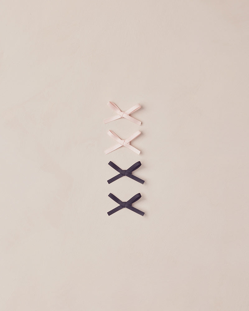 Four decorative bows on a beige background