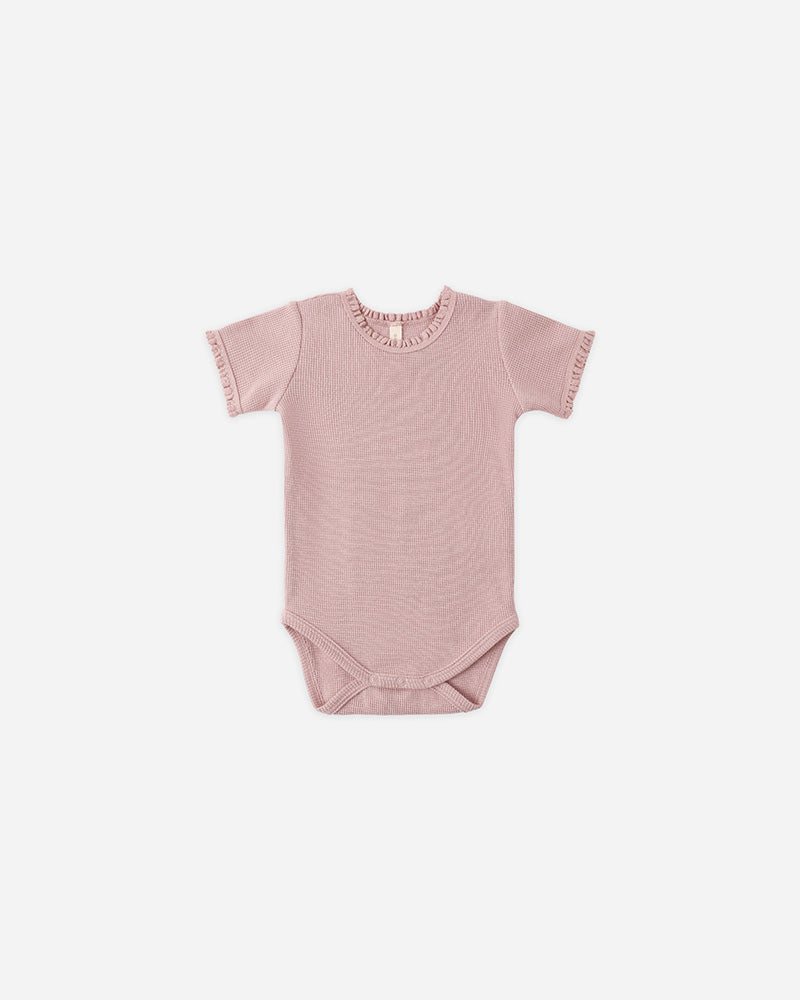Pink baby bodysuit with ruffled collar on a white background
