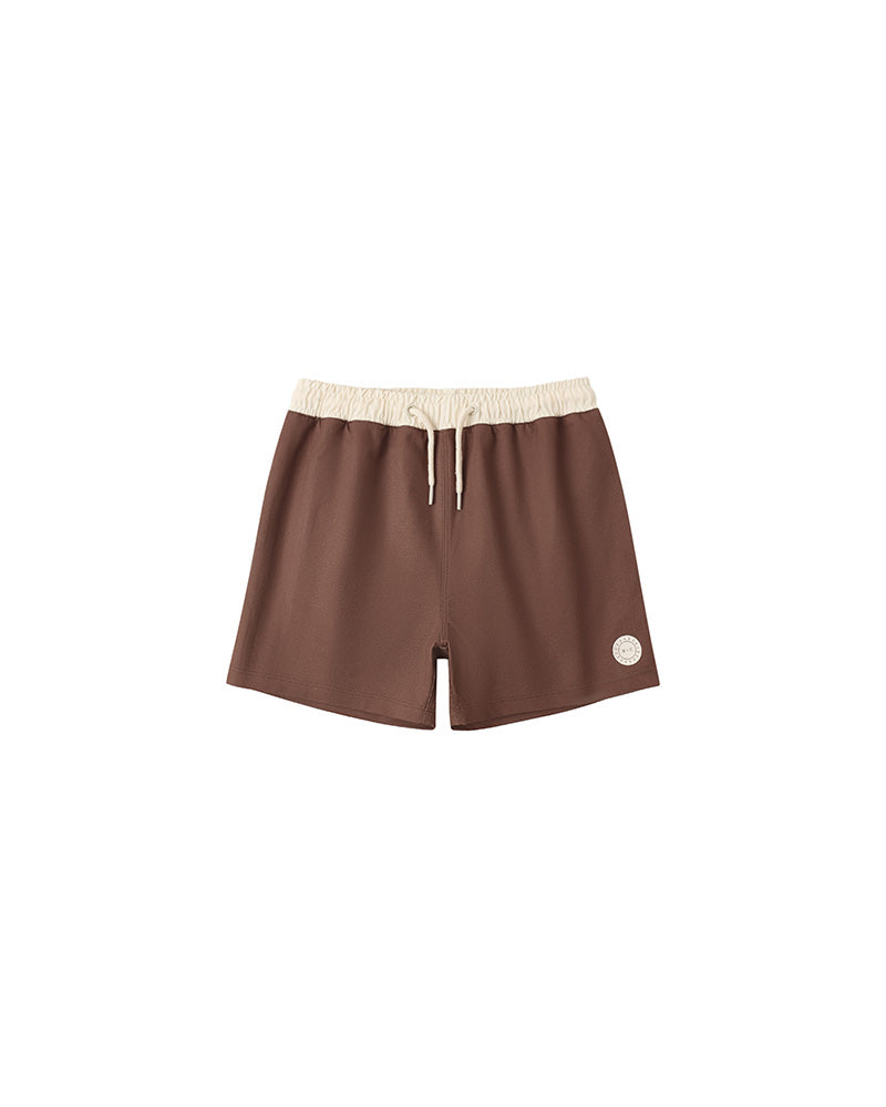 Brown shorts with a beige waistband on a white background