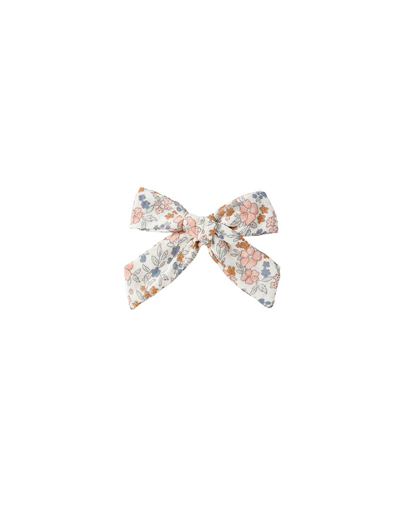 Floral bow hair accessory on a white background
