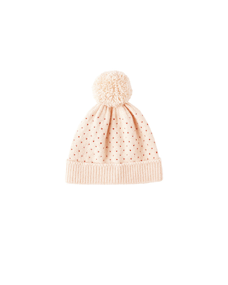 Pink speckled knit beanie with a pom-pom on a white background