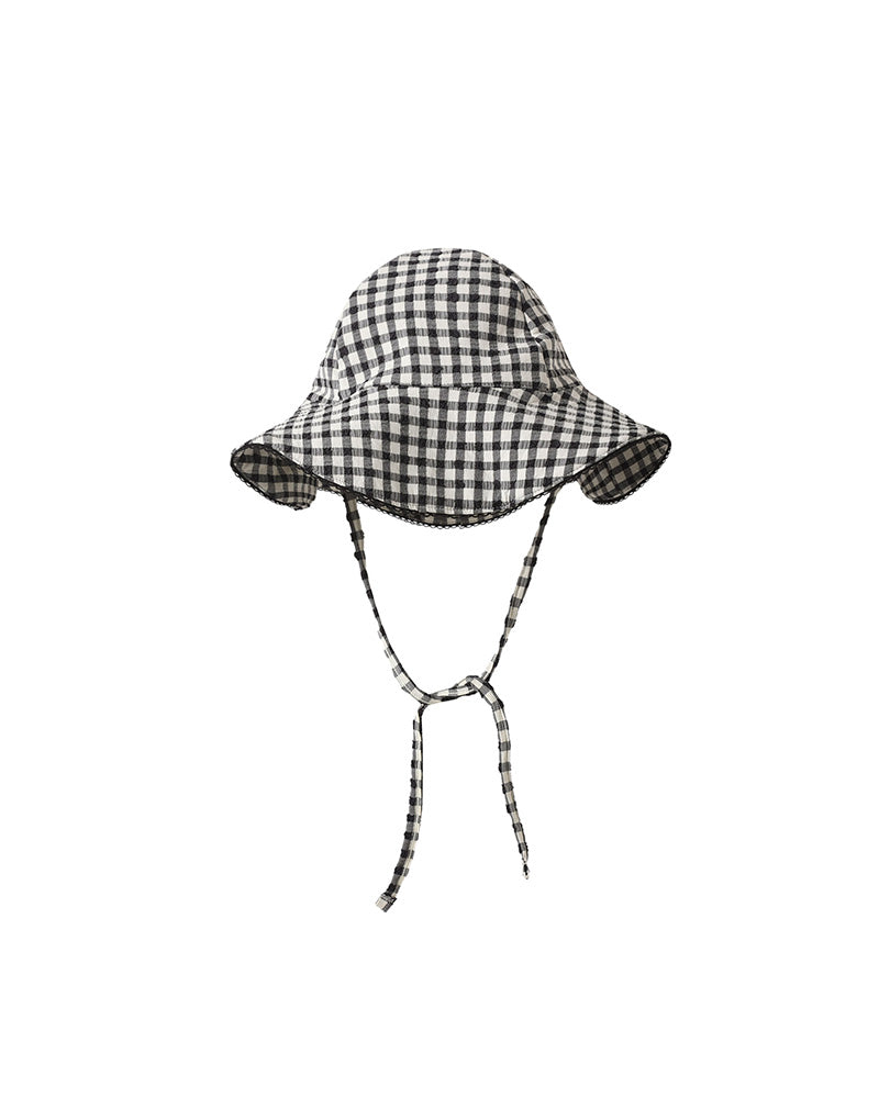 Black and white checkered bucket hat with a scalloped trim on a white background