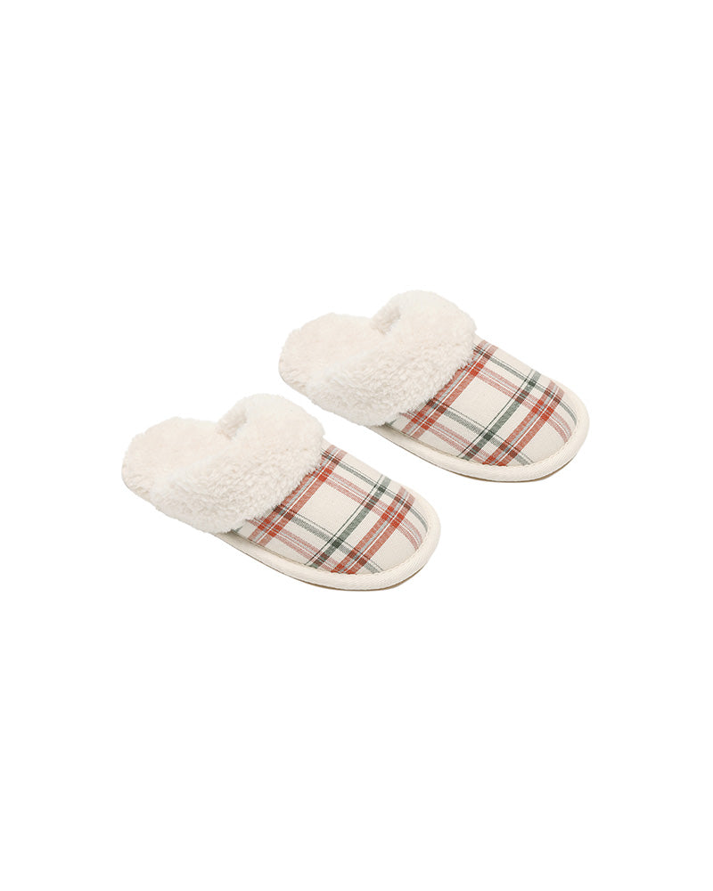 Pair of plaid slippers with white fur lining on a white background