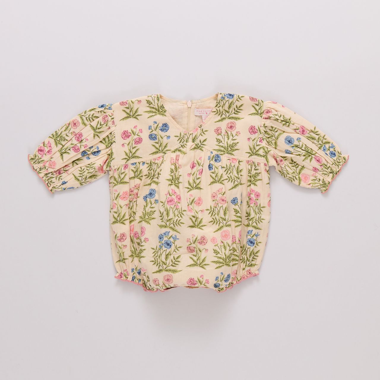 Floral-patterned baby romper on a light gray background