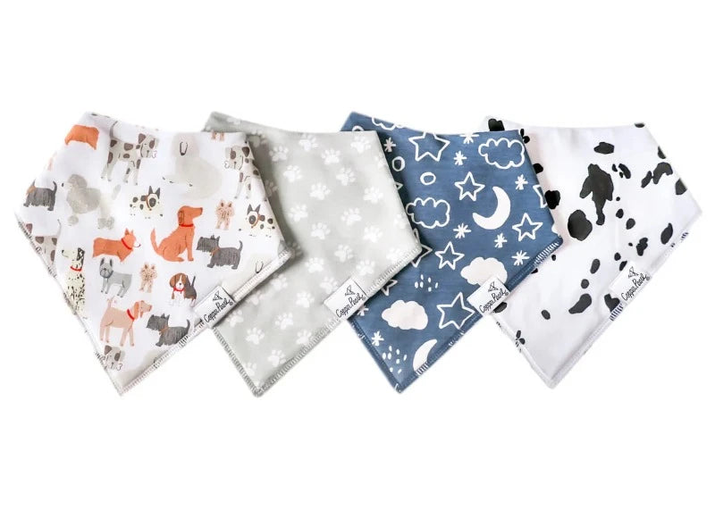 A set of four bandana bibs for babies, with various dog designs, displayed in a row.