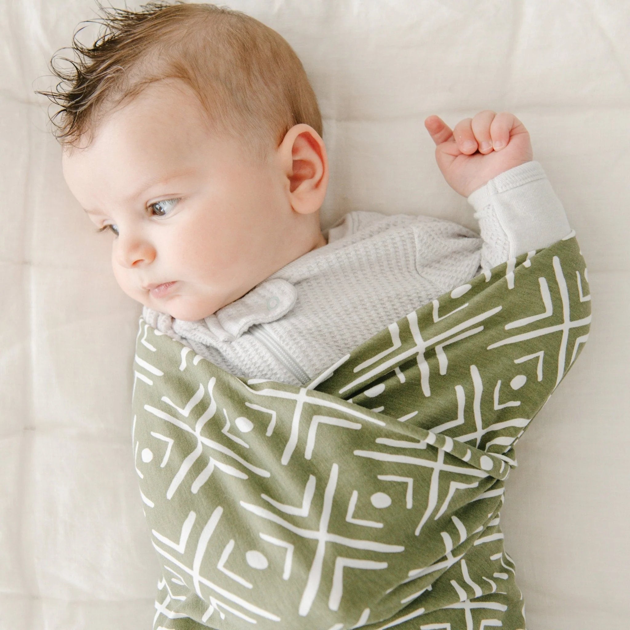 green mudcloth print swaddle