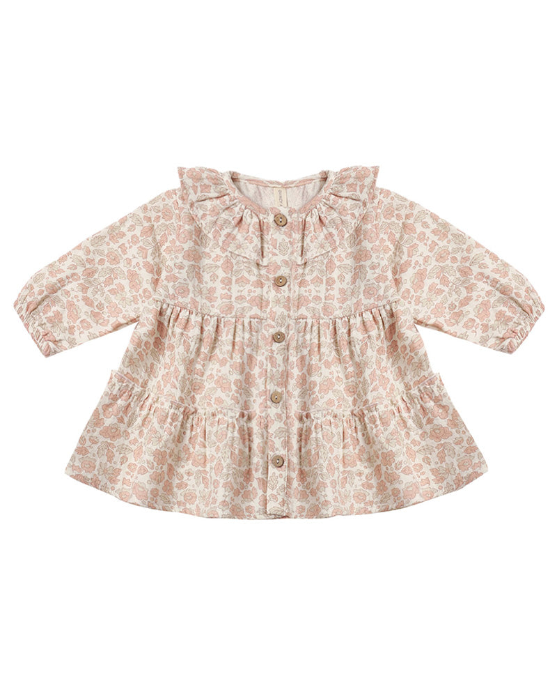 A toddler's long-sleeve button-up dress with a ruffled collar and a delicate pink and beige floral pattern, shown flat on a white background.