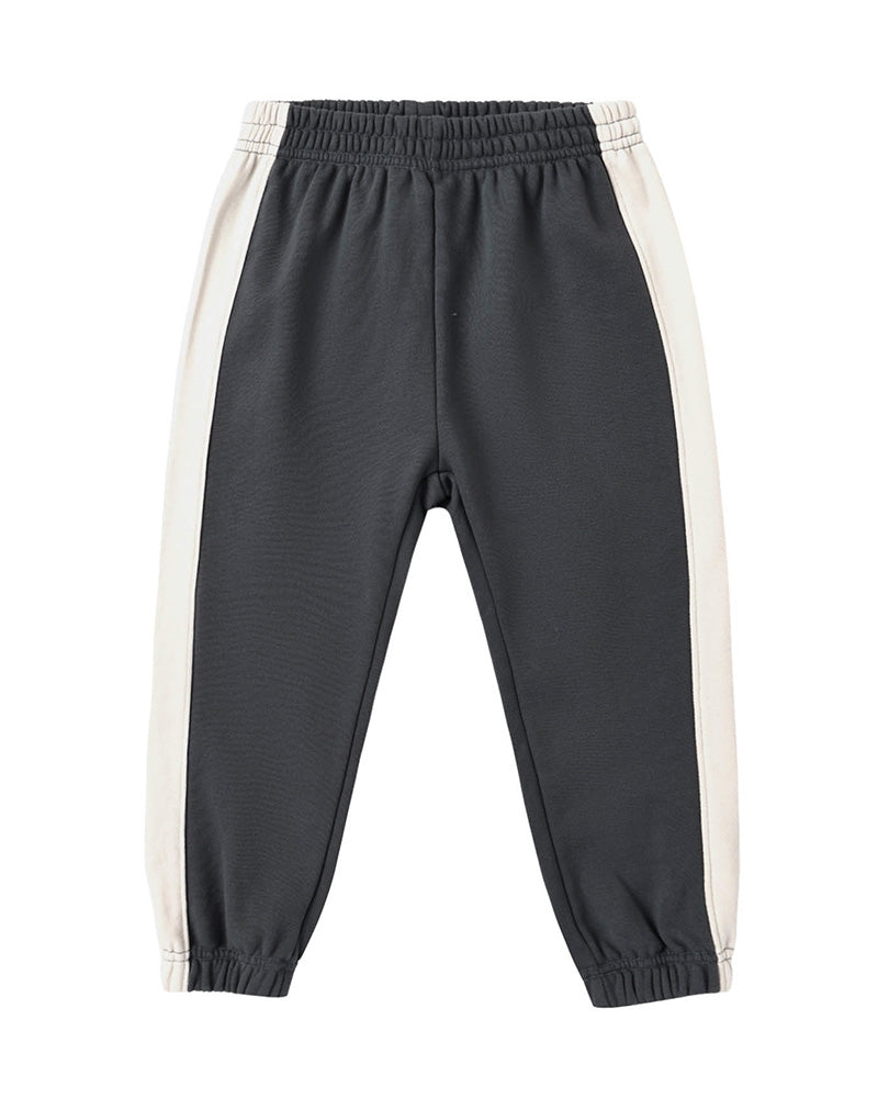 Black cuffed jogger pants with white side stripes on a white background