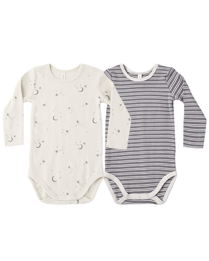 Two long-sleeve baby bodysuits laid flat on a white background. The left bodysuit is off-white with a small moon and star print and the right has a white and grey striped pattern.