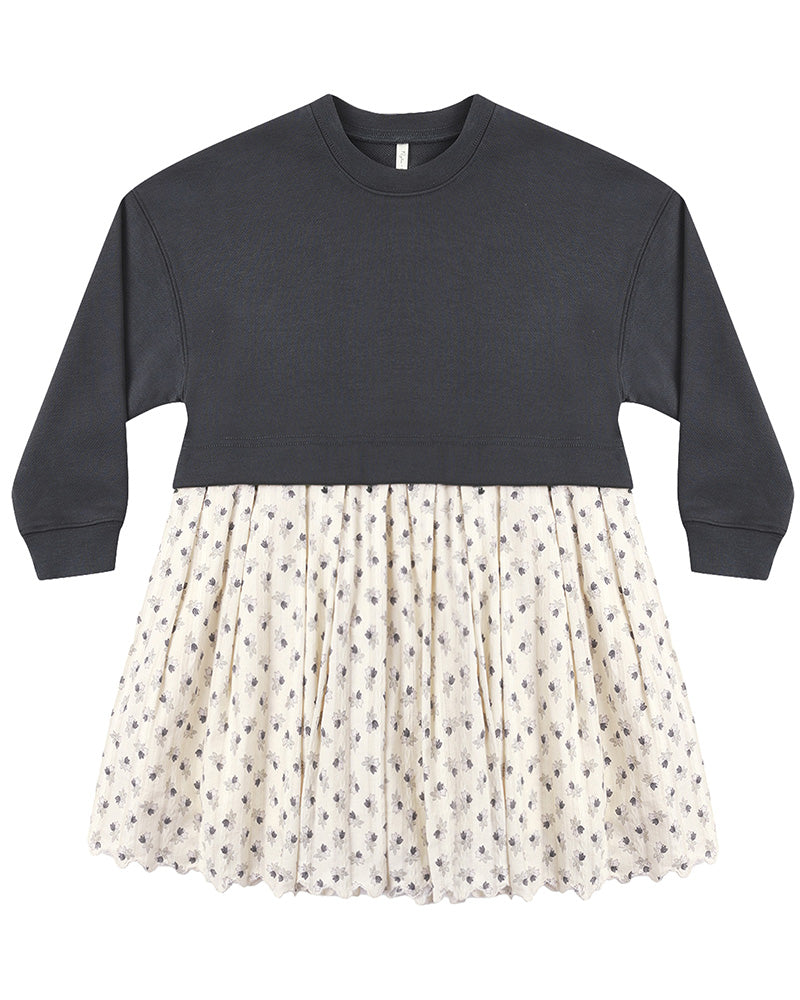 Two-tone dress with dark gray long sleeve top and floral patterned skirt on a white background