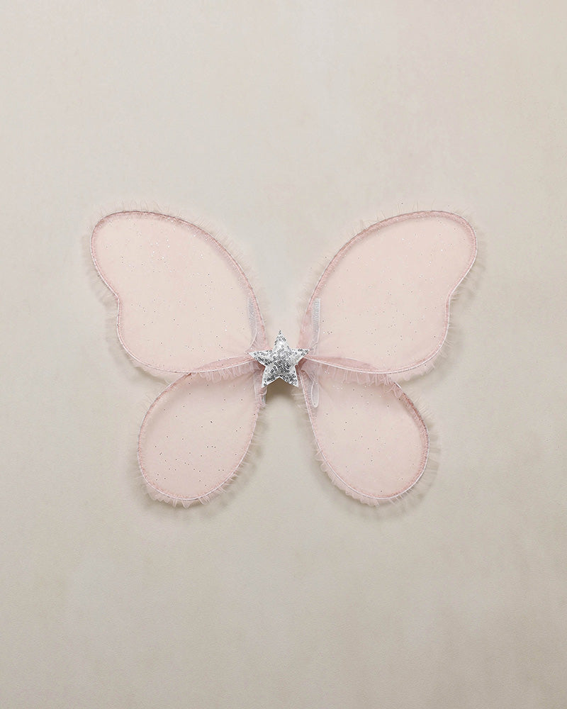 Pink butterfly-shaped wings with a central star on a beige background