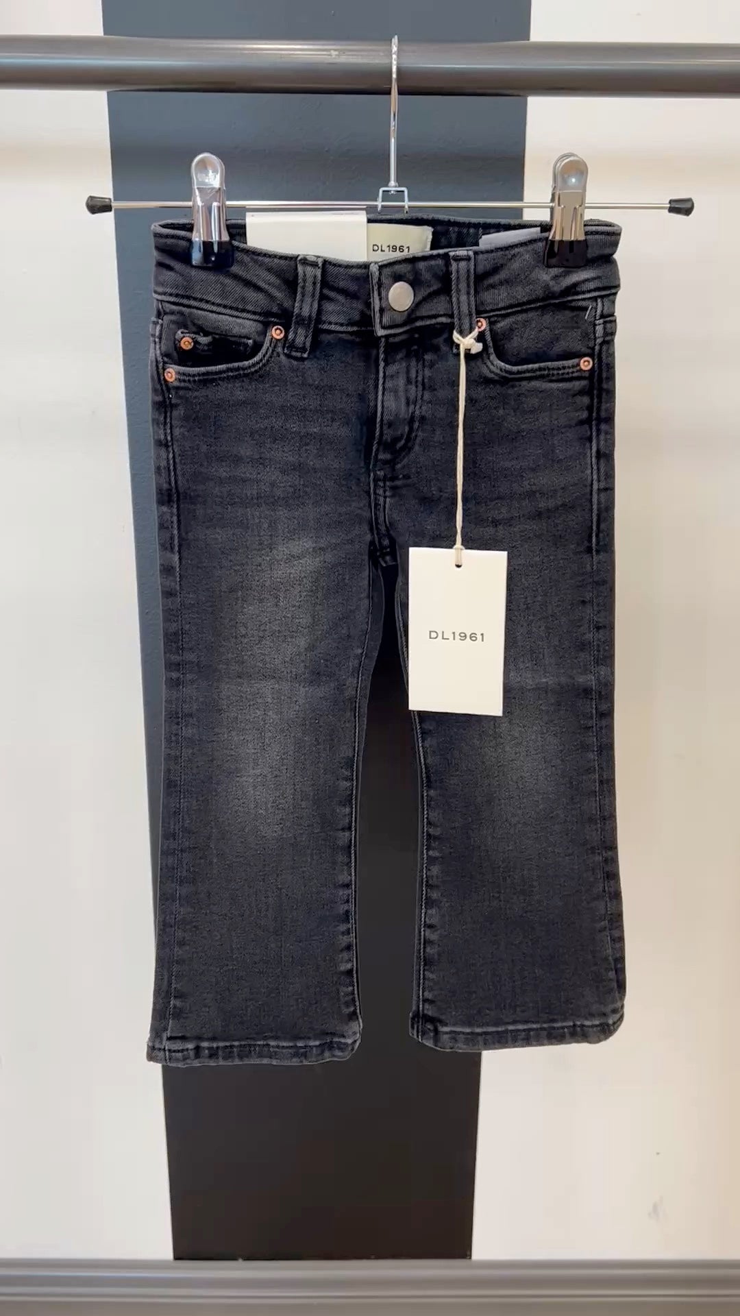 video of black DL jeans on hanger