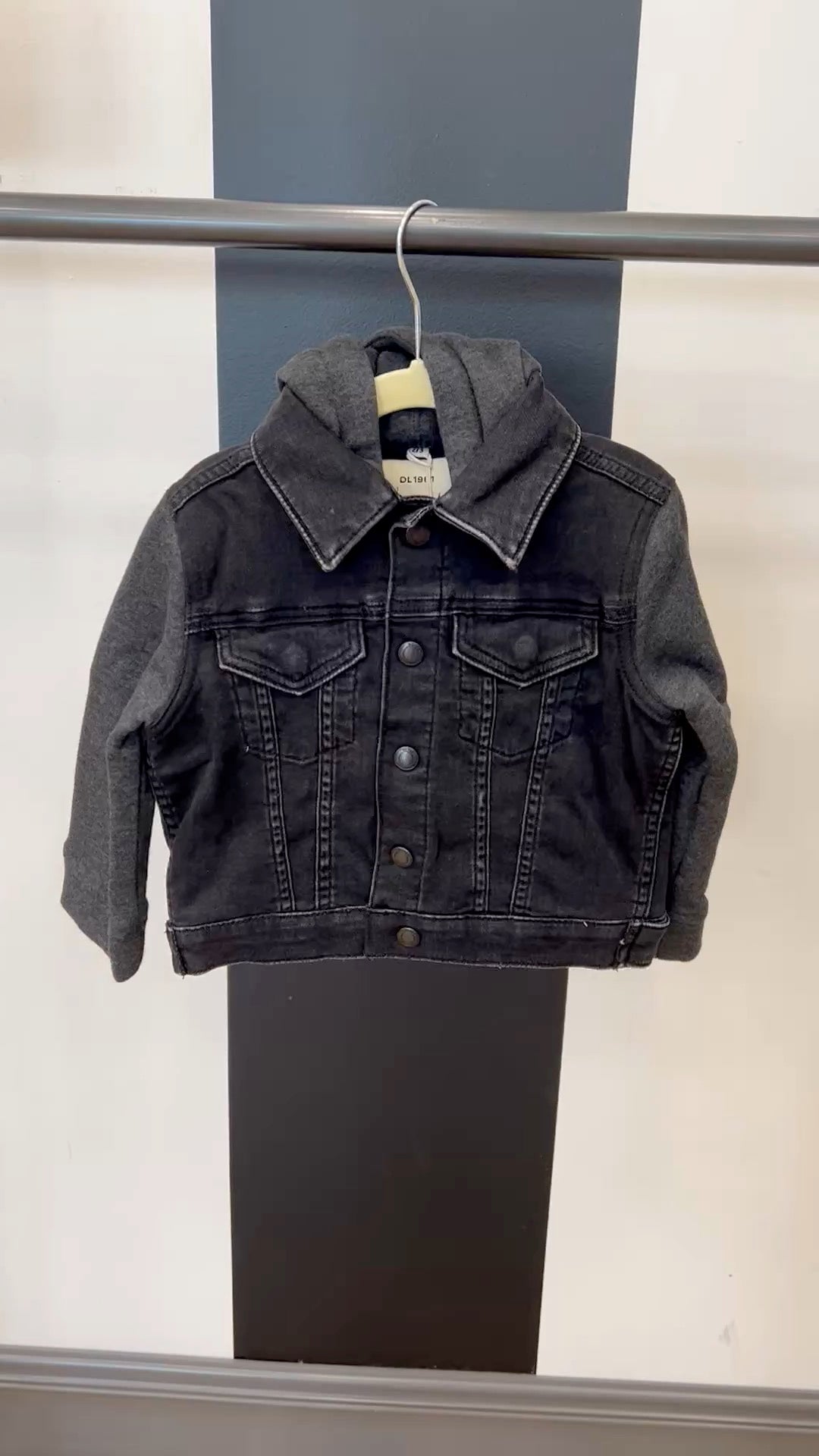 video of black denim jacket on hanger with hood