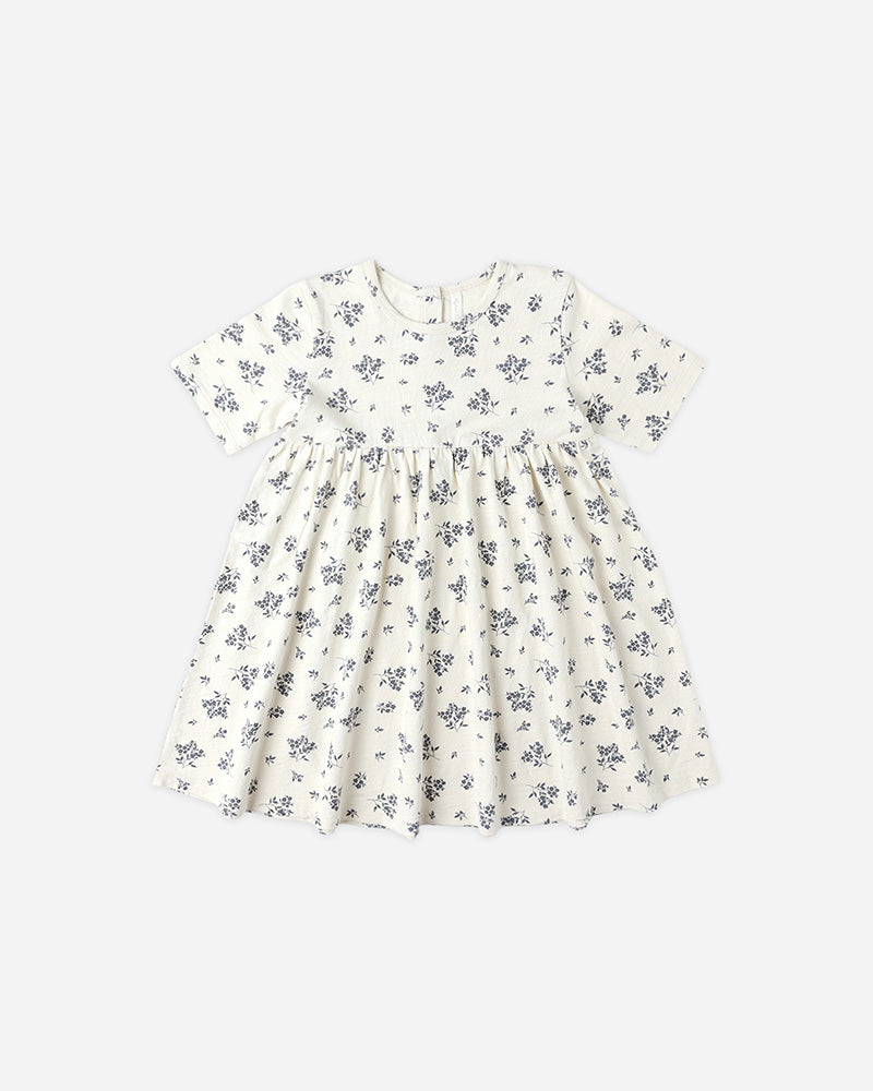 White dress with small blue floral pattern on a white background
