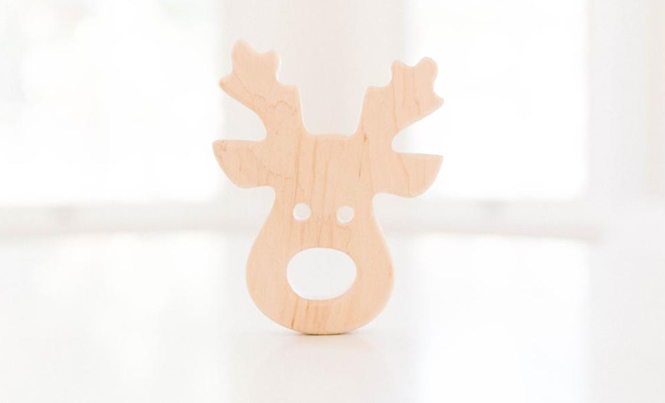 reindeer grasping wooden toy