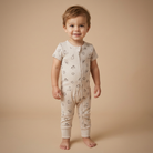 Child wearing a western patterned onesie on a beige background