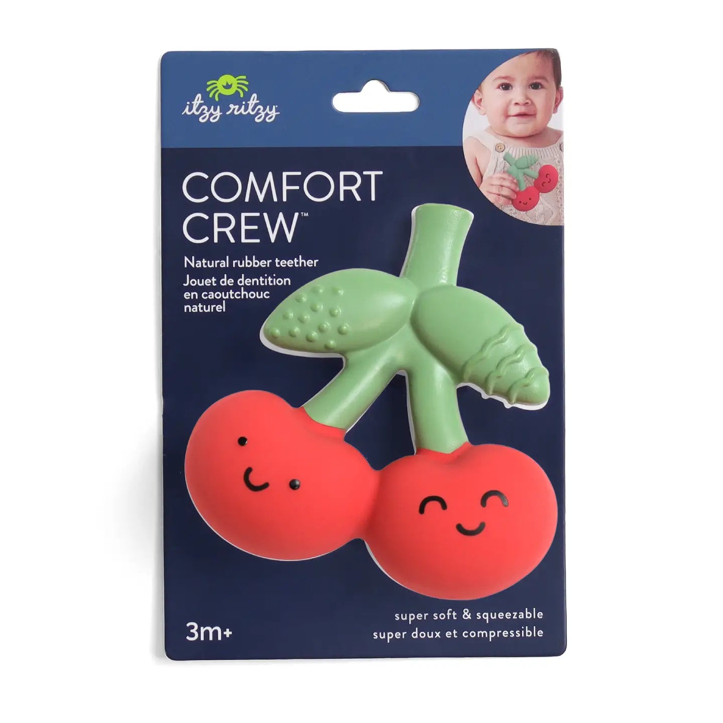 Green and red cherry teething toy with smiling faces on a blue packaging labeled 'Comfort Crew' by itzy ritzy.
