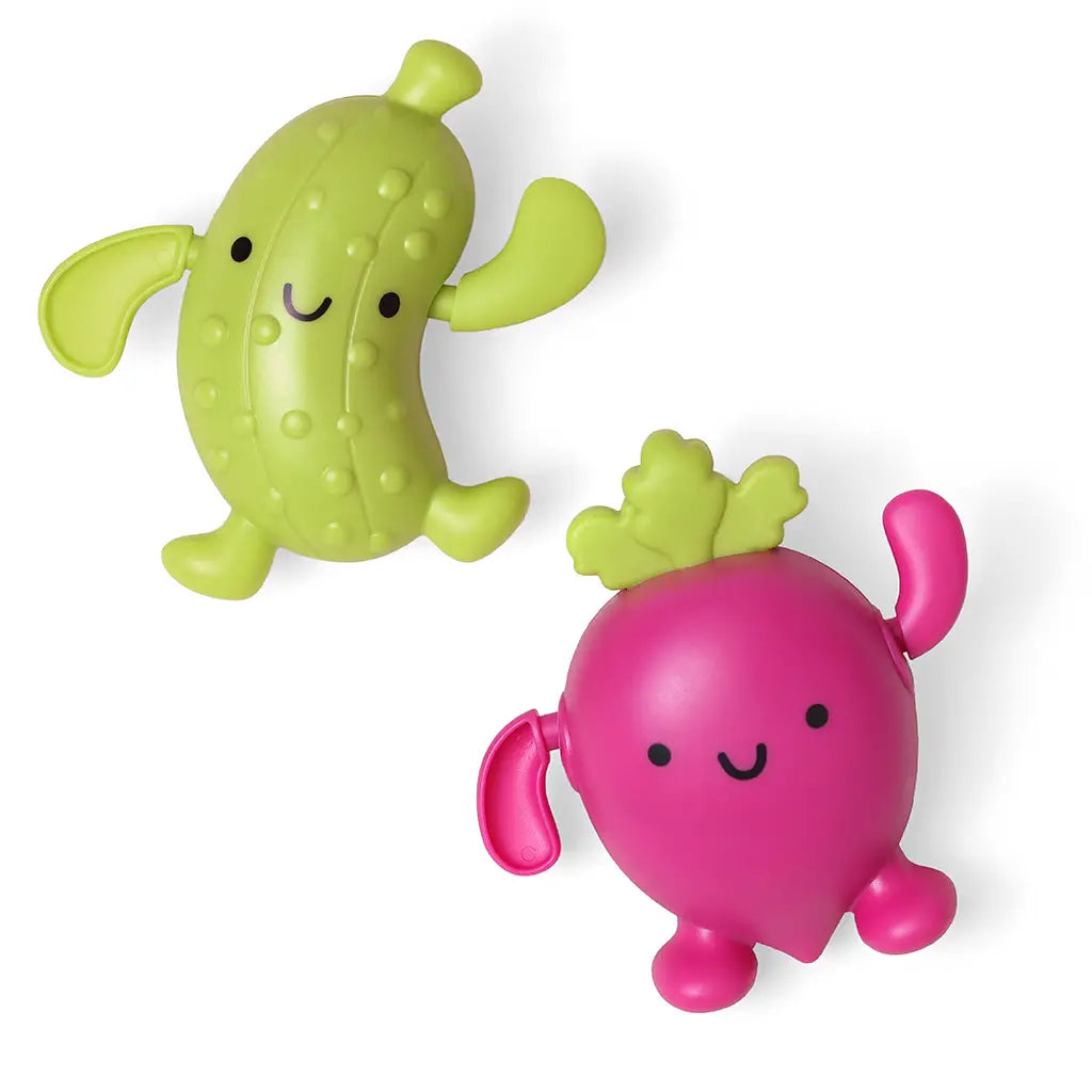 Two colorful bath toys, one green and one pink, on a white background