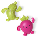 Two colorful bath toys, one green and one pink, on a white background