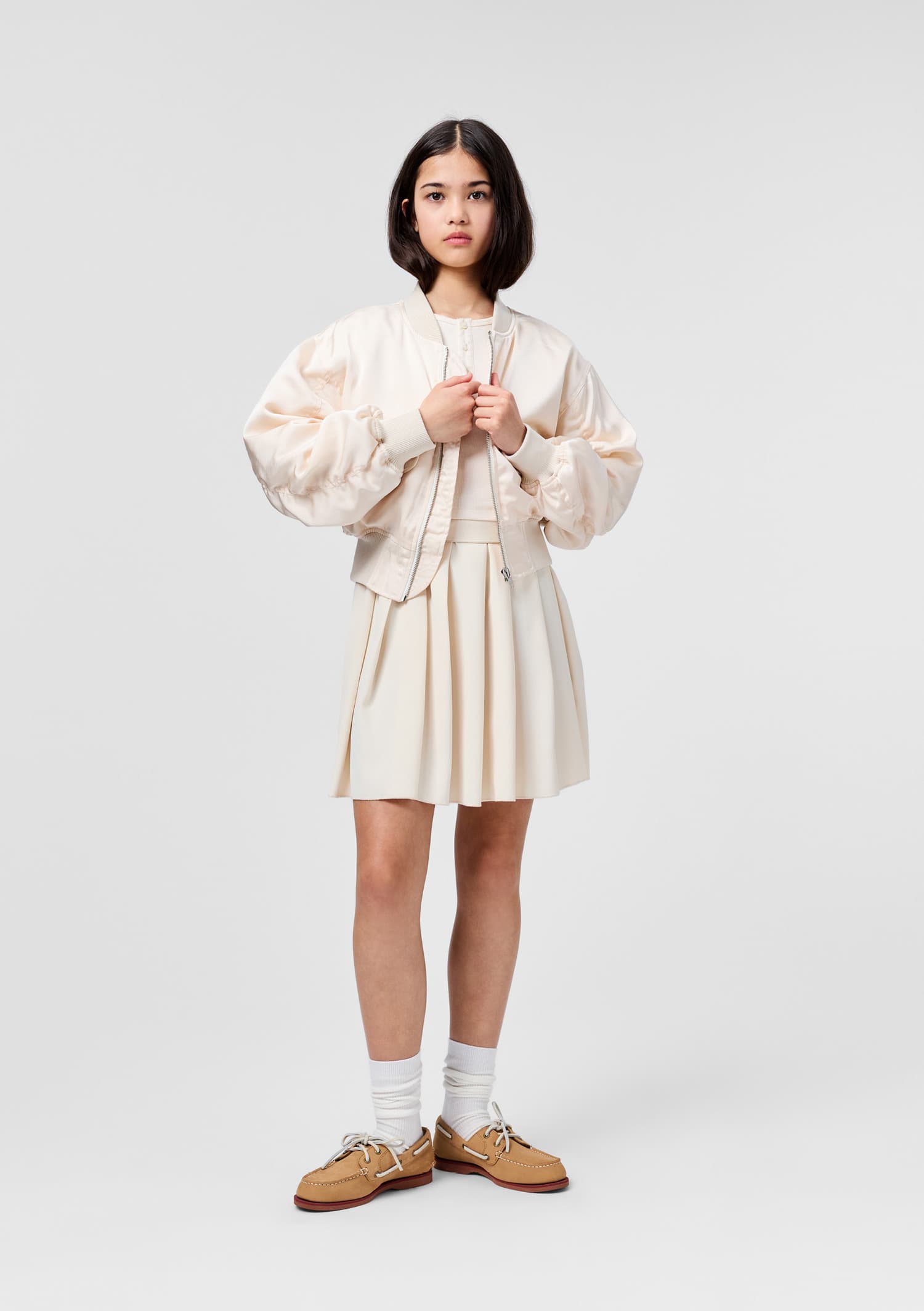 Person wearing a white pleated skirt