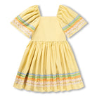 Yellow dress with colorful trim on a white background