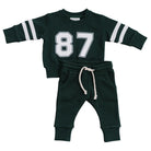 Green children's sweatshirt and pants set with number 87 and w white rope drawstring on a white background