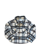 A long-sleeve plaid button-up shirt in cream, gray, and black, featuring two buttoned chest pockets and a pointed collar, laid flat against a white background.