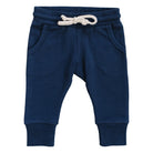 Blue baby jogger pants with a white rope drawstring and pockets on a white background