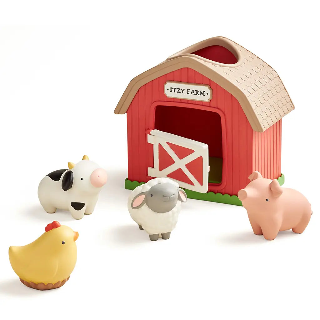 Toy barn with four farm animals on a white background