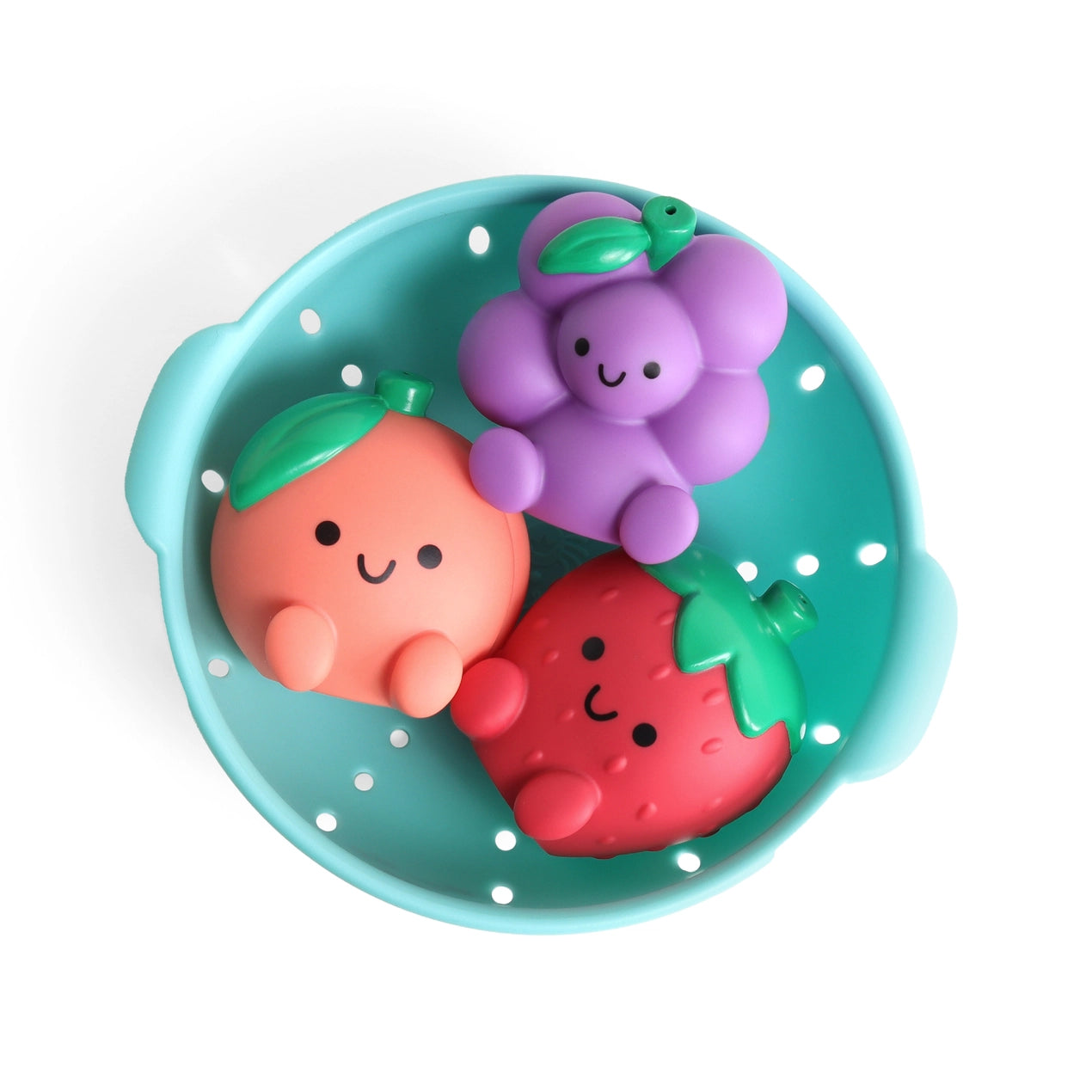 Colorful fruit-shaped bath toys in a teal bowl on a white background