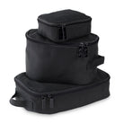Set of three black packing cubes stacked on a white background