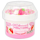 Pink whipped memory dough container with strawberry milk scent and accessories on a white background