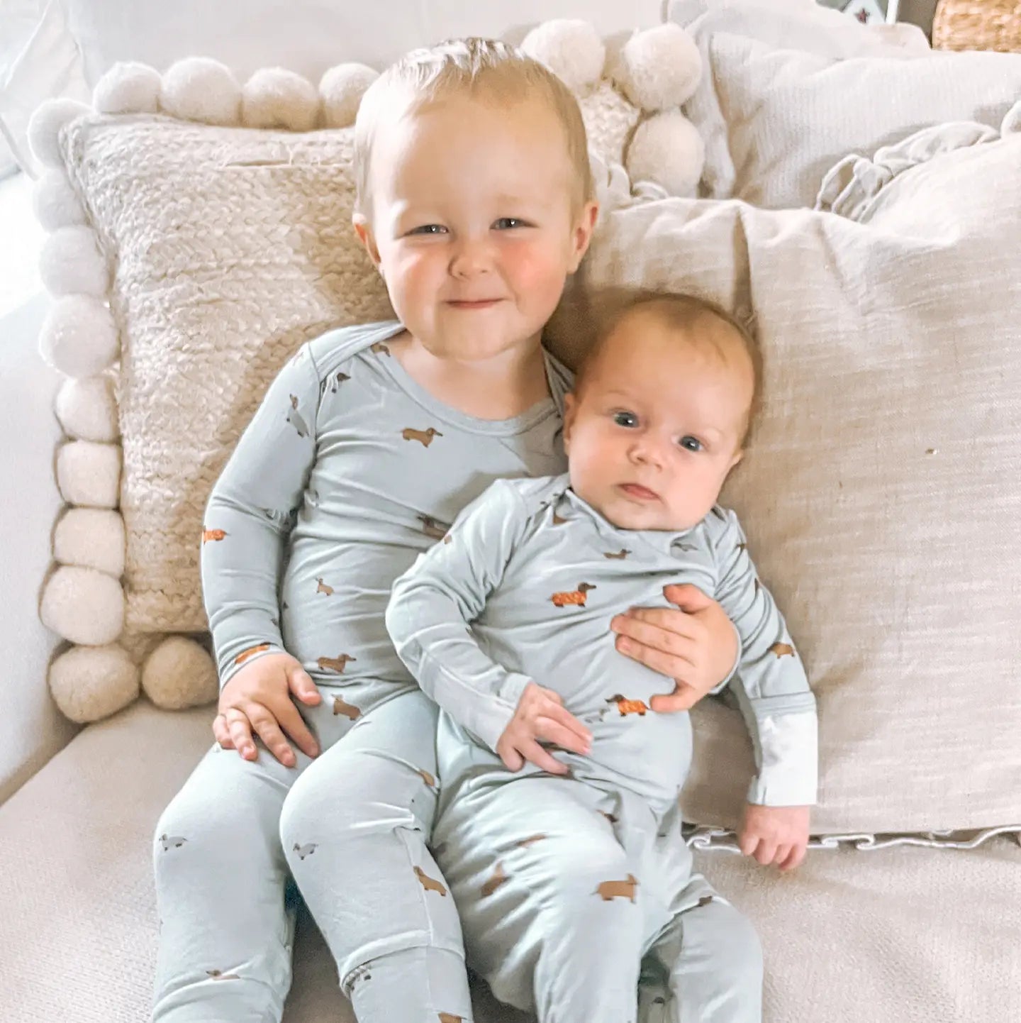 Light blue onesie with a dog pattern and zipper underneath