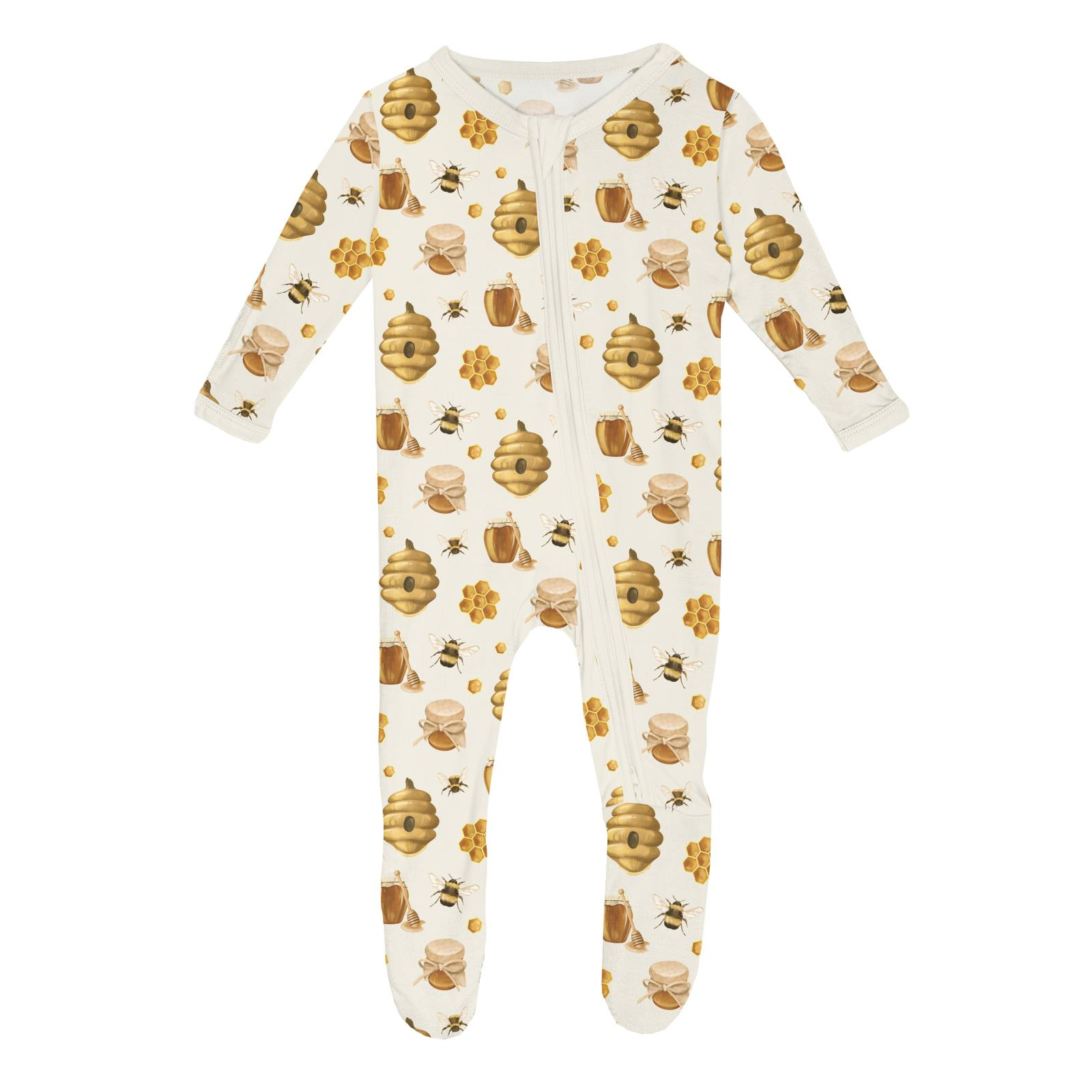 Baby onesie with honey and bee pattern on a white background