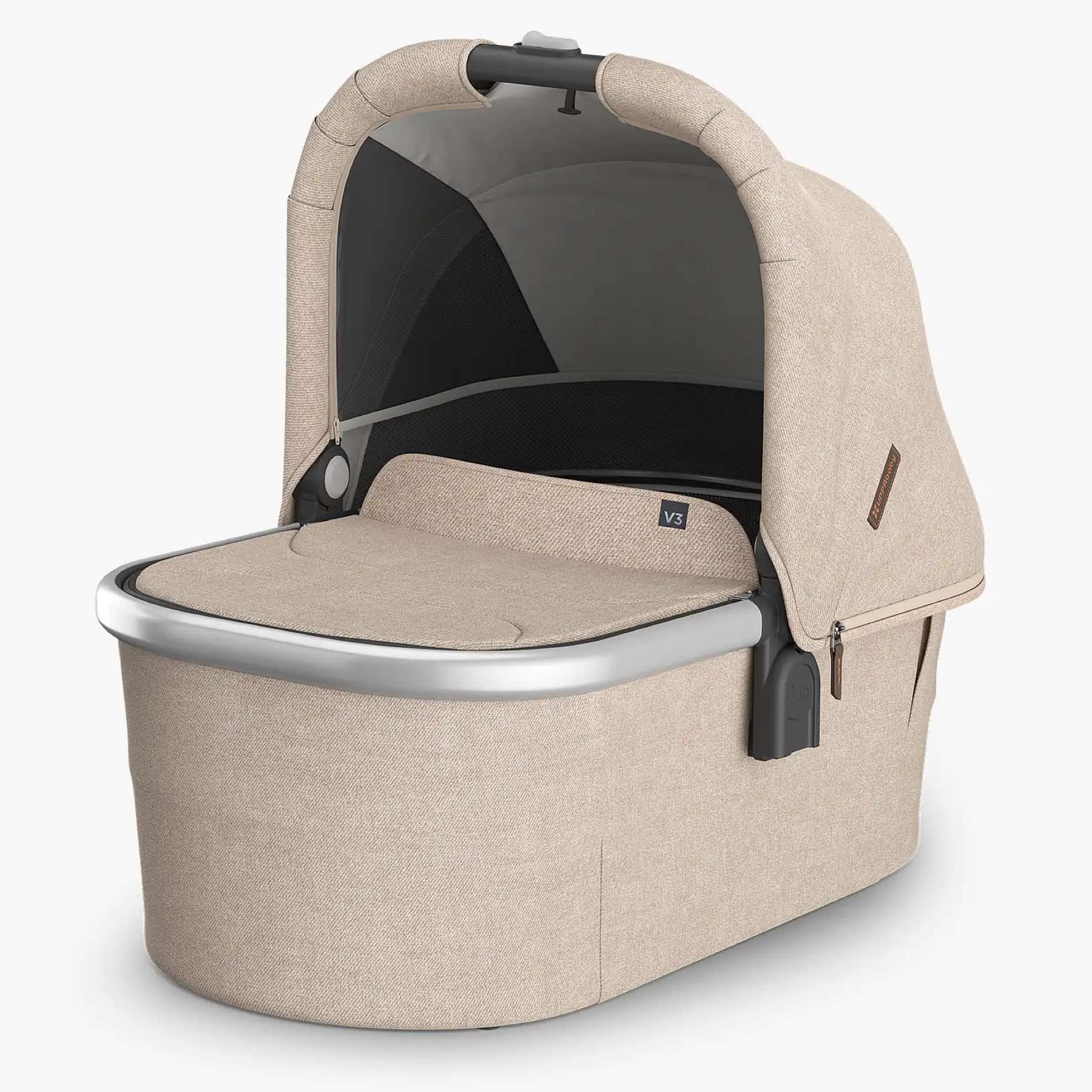 A beige UPPABABY Bassinet V3 with a sunshade, mesh panels, and a carry handle.