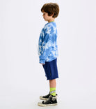 little boy standing wearing a blue and white tie dye sweatshirt