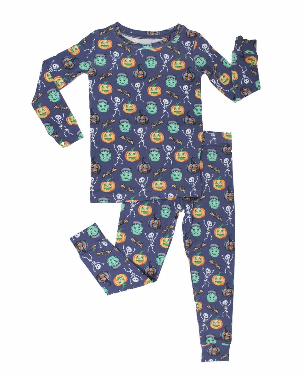 Children's Halloween-themed pajama set with pumpkins, ghosts, and skeletons on a blue background.